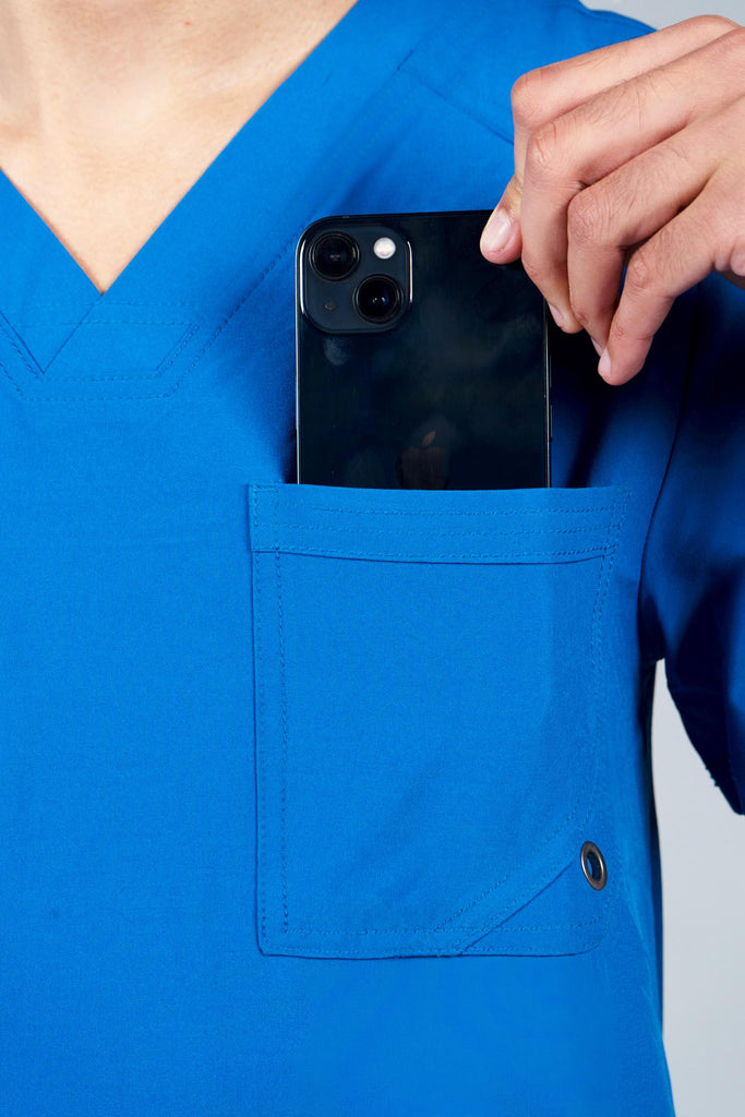 Men's Performance Scrub Top in Royal Blue model pulling phone out of pocket