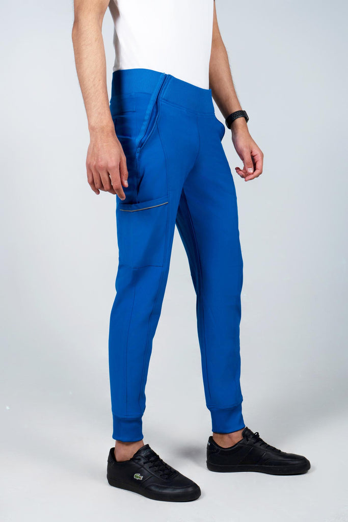 Men's Performance Scrub Jogger in shade royal blue worn by model with white top side view