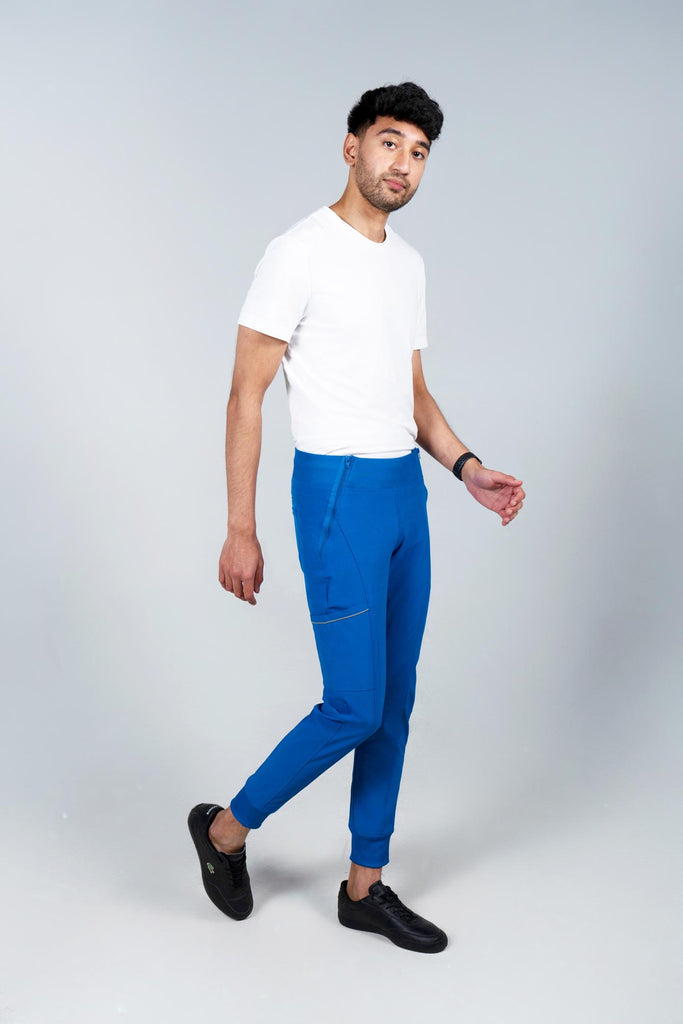 Men's Performance Scrub Jogger in shade royal blue worn by model with white top side view