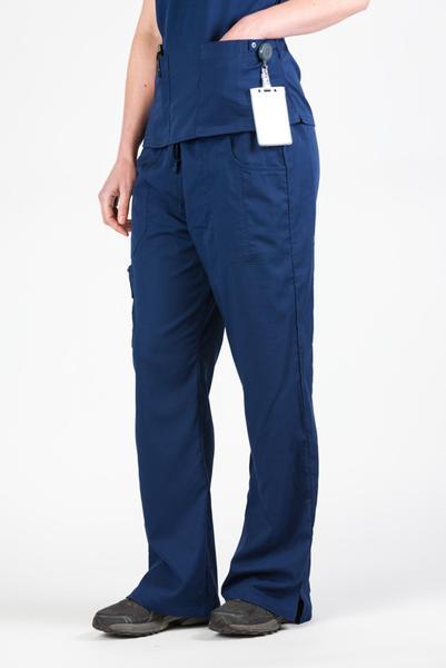 Women’s premium Flex Scrub Pants in shade navy shown from side paired with matching navy flex scrub top. Attached id badge hanging from utility loop