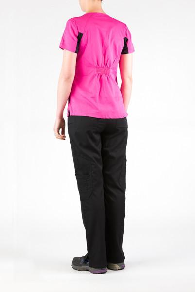 Women's Ultra Flex 4-pocket Scrub Top in pink on model wearing black flex scrub pants from behind