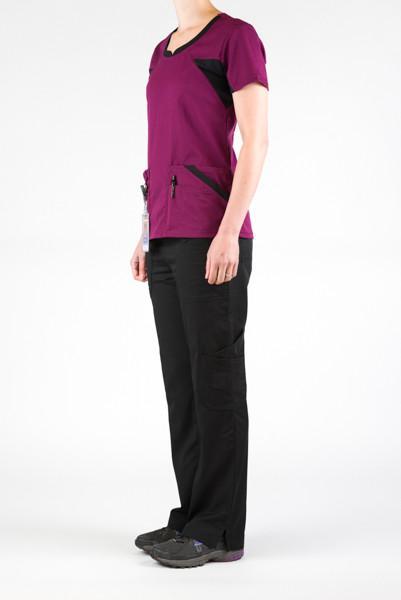 Women's Ultra Flex 4-pocket Scrub Top in wine on model wearing black flex scrub pants side view 