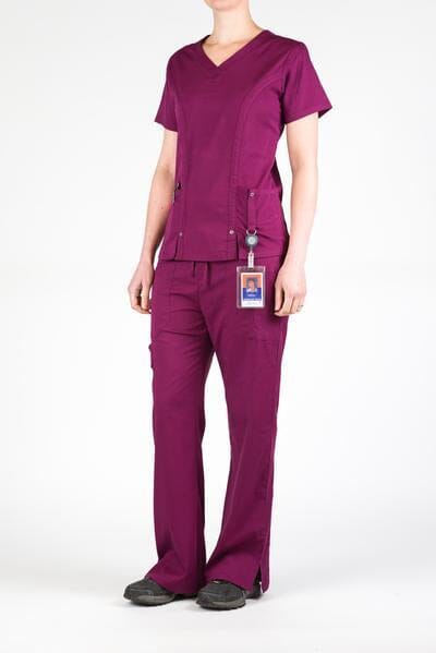 Women’s premium Flex 3-Pocket Scrub Top in shade wine paired with matching scrub set women's Flex Pants in shade wine front view with id badge hanging from utility loop