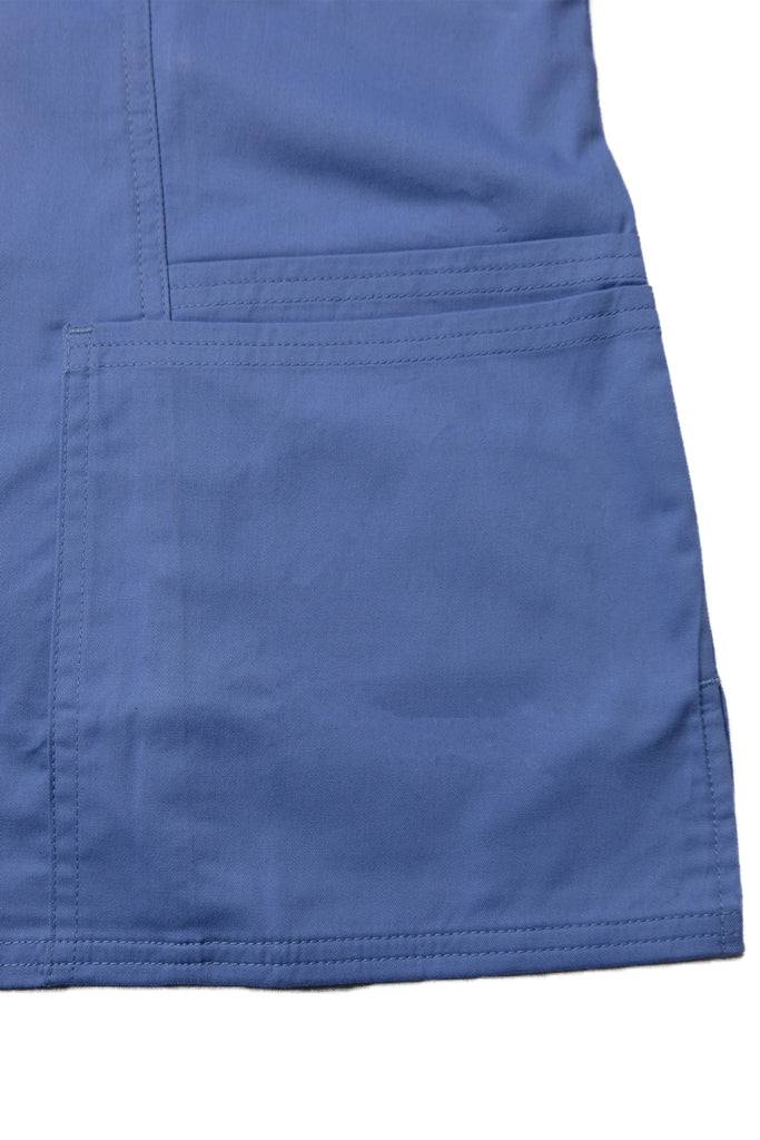 Women's 4-Pocket Curved V-Neck Scrub Top in Periwinkle closeup on bottom pockets